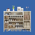 White Shoe Cabinet with Multiple Compartments for Various Shoes and Decorative Items on Top