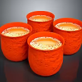 Four Orange Textured Mugs With Foamy Liquid For Daily Household Use