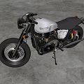Vintage Silver and Black Motorcycle with Black Leather Seat on Industrial Gray Concrete Floor