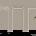 White Decorative Door Frames With Beige Wall And Green Plant Accents