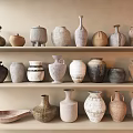 Decorative Ceramic Vessels with Various Shapes and Colors on Three Light Shelves