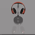 Orange Over Ear Headphones Placed On Chrome Metal Stand With Reflective Surface