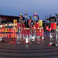 Vibrant Plaza Landscape With Colorful Lanterns Circular Light Decorations And People At Night