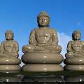 Three Buddha stone sculptures outdoor by pond with lotus and blue sky