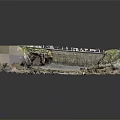 Rocky Coastal Terrain Featuring Cave Moss Covered Stone Walls Sandy Ground And Pebbles
