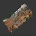 Layered Terrain Landscape With Red Brown White Color Patterns And Green Vegetation Patches