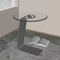 Modern Round Glass Top Side Table with Metal Base and Open Book on Marble Floor