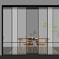 Modern Glass Sliding Doors With Black Frame In Dining Area Featuring Wooden Table And Plants
