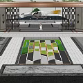 Modern Architectural Entrance Gate With Wooden Roof Lush Greenery And Paved Driveway