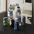 Assorted Beverages Including Biza Bottled Water PEPSI Cans And Canned Drinks On Table