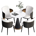 Modern Round Dining Table Set with White Chairs Dark Armrests Black Base and Green Plant