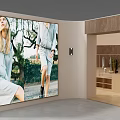 Clothing Store Interior With Large Billboard Models In Light Colored Outfits And Wooden Decor