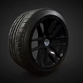 Black Car Wheel With Five Spoke Rim And Deep Tread Pattern 3d model