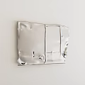 Silver Metal Decorative Panel With Irregular Edges Wrinkles Holes On White Wall