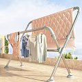 Foldable Metal Clothes Drying Rack With Hanging Clothes And Pink Blanket On Balcony