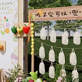 Colorful Parent Child Fruit Themed Photo Check in Spot With Welcome Sign Flowers And Grass Decorations
