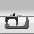 Sleek Modern Glass Top Coffee Table With Black Curved Base And Small Remote Control Device