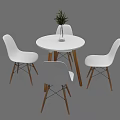White Leisure Chairs With Wooden Legs Around Round Table And Green Plant