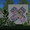 Outdoor Floral Cross Installation with Blue Purple Pink Flowers White Backdrop Green Plants and Lawn