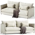 Modern Two Seater Sofa With Light Beige Upholstery Cushions And Throw Blanket