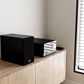 Black Audio Speaker System On Wooden Cabinet With Remote Control And Window Blinds