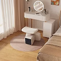 White Padded Stool on Round Rug with Dressing Table in Modern Bedroom