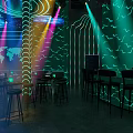 Modern Bar Interior With Neon Lights Bar Counter Tables Chairs And Futuristic Decor