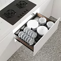 Modern Kitchen Interior With Open Drawer Neat Plates Bowls Black Gas Stove And White Cabinets