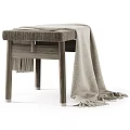 Wooden Stool With Woven Seat And Beige Fringe Blanket Draped Over