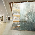 Spacious Shopping Mall Lobby With Glass Staircase High Ceiling And Reflective Floor Design