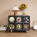 Black Bedside Table With Six Patterned Drawers Lamp Sunflowers And Books