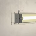 Modern Linear Chandelier With White Light Hanging In Concrete Wall Interior