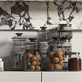 Stylish Glass Spice Jars Arranged On Kitchen Shelf With Marble Backdrop And Books