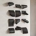 Black Irregular Shaped Wall Decor Mounted On Light Colored Wall 3d model