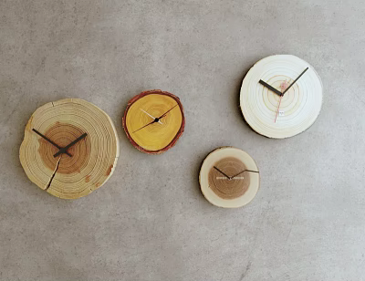 Four Wooden Clocks with Tree Stump Slice Shape Hanging on Gray Wall 3d model