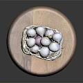 Fresh Garlic Bulbs in Wicker Basket on Wooden Cutting Board Against Black Background