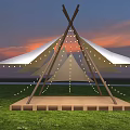 Outdoor Stage With Canvas Canopy String Lights And Wooden Platform On Grass Field At Sunset