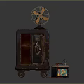 Vintage Dark Furniture Cabinet With Open Door Shelf Wheels Fan On Top Colorful Box Beside