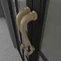 Beige Curved Decorative Door Handles Mounted On Dark Door With Gray Wall Background
