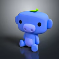 Blue Cartoon Monkey Toy with Green Leaf on Head Sitting on Black Surface with Reflection