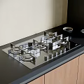 Modern Kitchen Gas Stove On Black Countertop With Wooden Cabinets