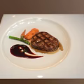Grilled Steak Plated with Green Vegetables Carrots and Red Sauce on White Square Plate