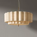 Beige Fabric Chandelier With Pleated Wave Design And Multi Layer Metal Frame Against Gray Wall