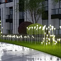 Outdoor Lights Illuminating Green Lawn with Tall Slender Stems Near Building and Trees