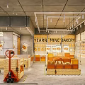 Modern Bakery Interior With Fresh Breads Display Shelves Wooden Crates And Hanging Lights