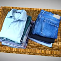 Wicker Home Organization Basket With Neatly Folded Shirts Jeans And Clothes