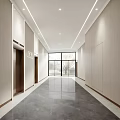 Modern Elevator Hallway With Light Colored Walls Dark Floor Linear Ceiling Lights And End Window
