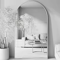 Large Arched Mirror Reflecting Cozy Living Room With Sofa Pillows And Decorative Tree