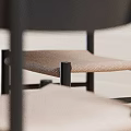 Black Round Dining Table Set With Chairs Vase Fruit Plate Beige Walls And Skylight