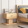 Wooden Bedside Table Next to Bed With Photo Frame Dried Flowers And Mug On Top